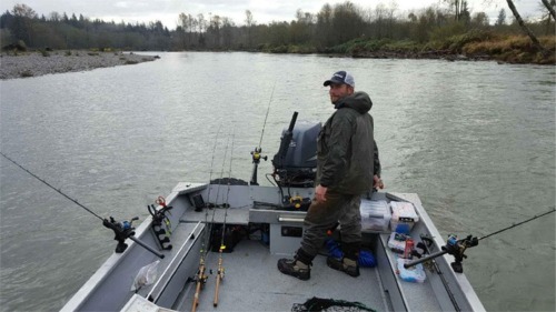 Fishing Guide Patric Gaffney pulling plugs for fall coho and chinook  in high water conditions